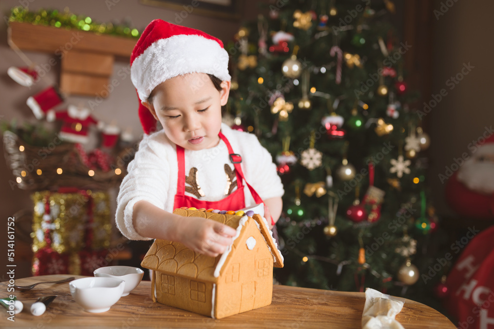 young girl making gingerbread house at home