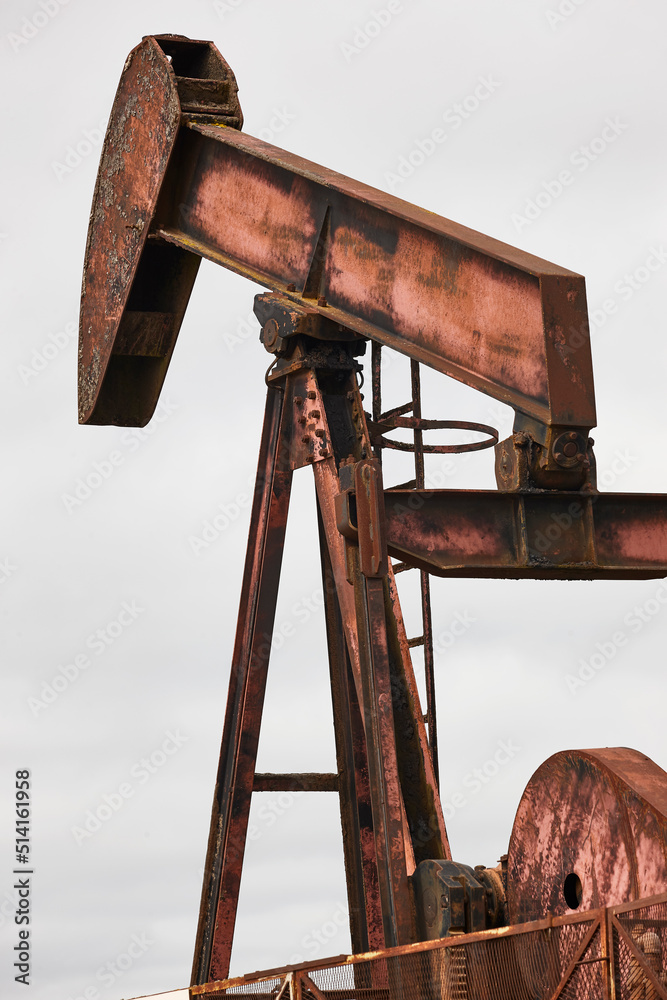 Oil pumping machine. Pump jack. Petroleum extraction. Global warming