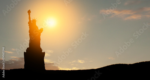 Silhouettes of The Statue of Liberty at sunset. Greeting card for Independence Day.
