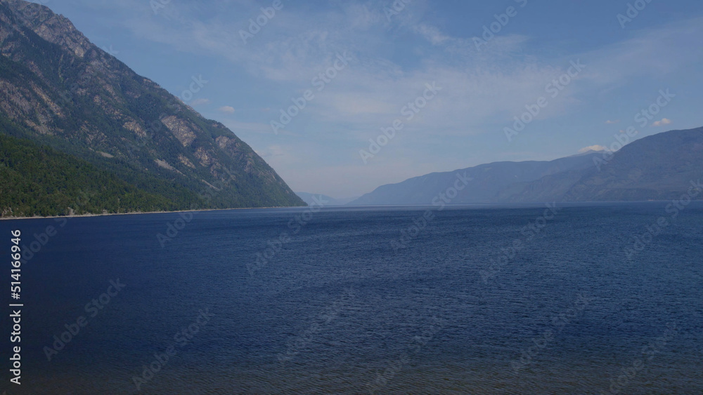 Lake Teletskoye between mountains with blue clear sky in Altai