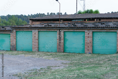 Image of garages with turquoise doors in an abandoned factory photo