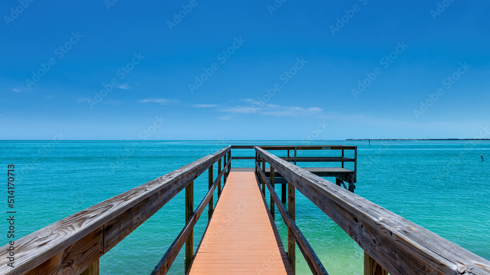Wooden pier and turquoise sea in tropical beach in Florida Keys