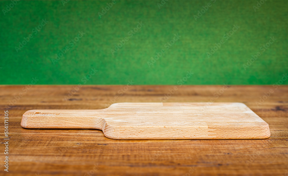 cutting board close up on wooden table on green background