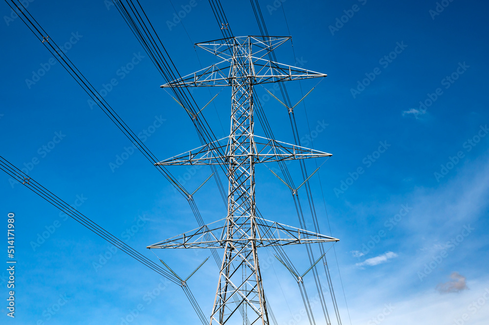 Standing street light post, electric pole and high voltage tower.High voltage transmission pole sunlight with blue sky background. Standing street light post, electric pole and high voltage tower.High voltage transmission pole sunlight with blue sky background.