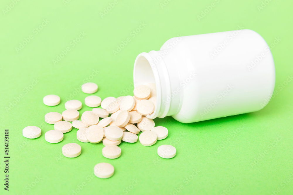different drugs and health supplement pills poured from a medicine bottle health care and medical top view on colored background different drugs and health supplement pills poured from a medicine bottle health care and medical top view on colored background
