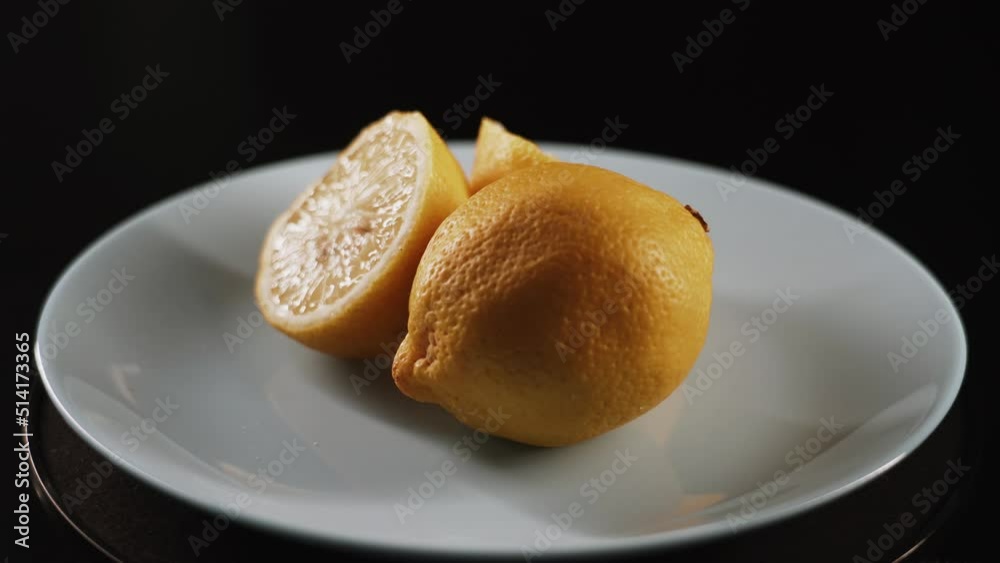 Fresh spinning lemons on black background.Lemon Tasty lemons isolate on the black background close up 4k Fresh spinning lemons on black background.Lemon Tasty lemons isolate on the black background close up 4k