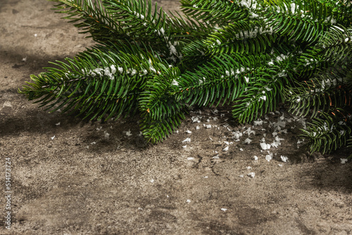 Merry Christmas wreath made of fir branches on stone concrete background