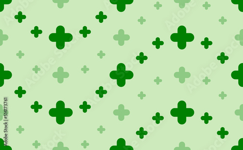 Seamless pattern of large and small green quatrefoil symbols. The elements are arranged in a wavy. Vector illustration on light green background