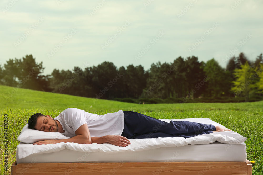 Man sleeping on bed and beautiful view of green lawn on background. Sleep well - stay healthy Man sleeping on bed and beautiful view of green lawn on background. Sleep well - stay healthy