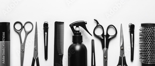 Set with scissors and other hairdresser's accessories on white background, flat lay. Banner design photo
