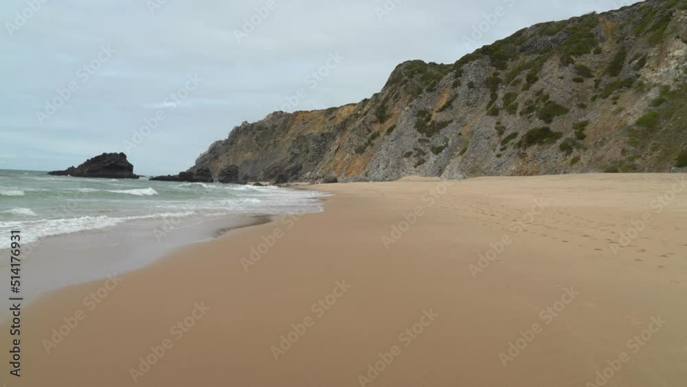 Beach Filled with Footprints on Sand in Gruta da Adraga Beach Filled with Footprints on Sand in Gruta da Adraga