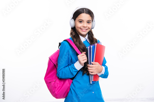 School girl, teenager student in headphones on white isolated studio background. Music school concept.
