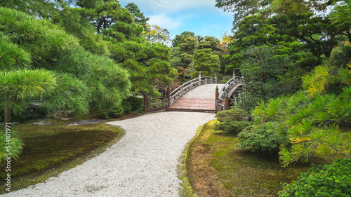 A path leading to a historic bridge in Gonaitei Japanese garden - Imperial palace, Kyoto, Japan.