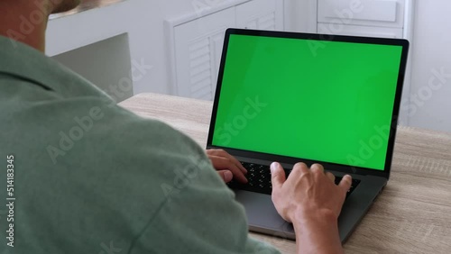 Business man freelancer working at laptop computer from home, green screen chroma key. 