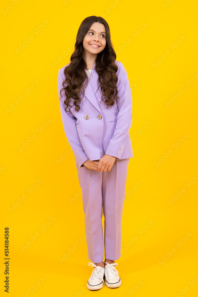 Obraz premium Full length photo of pretty teenager child girl wear casual clothes isolated on yellow background. Happy teenager, positive and smiling emotions of teen girl.
