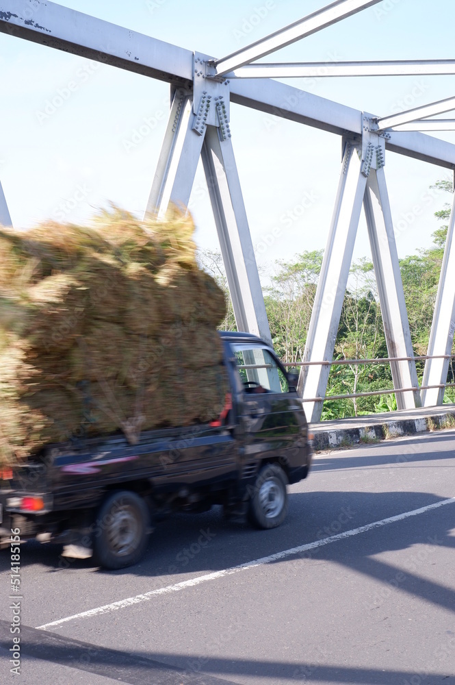 truck on the road or iron bridge or jembatan konstruksi besi di kali Luk Ulo, Kebumen, Jawa Tengah, Indonesia