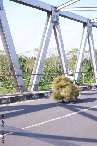 bicycle on the road or iron bridge or jembatan konstruksi besi di kali Luk Ulo, Kebumen, Jawa Tengah, Indonesia photo
