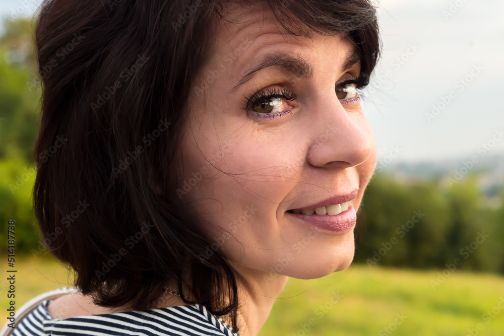 Close-up portrait of a woman 40-44 years old with short black hair.