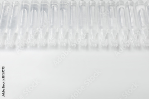 Single dose ampoules of sterile isotonic sea water solution on white background. Space for text