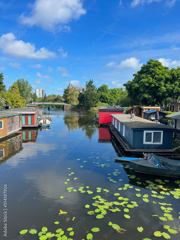 Fototapeta premium Beautiful view of canal with floating houses and boat