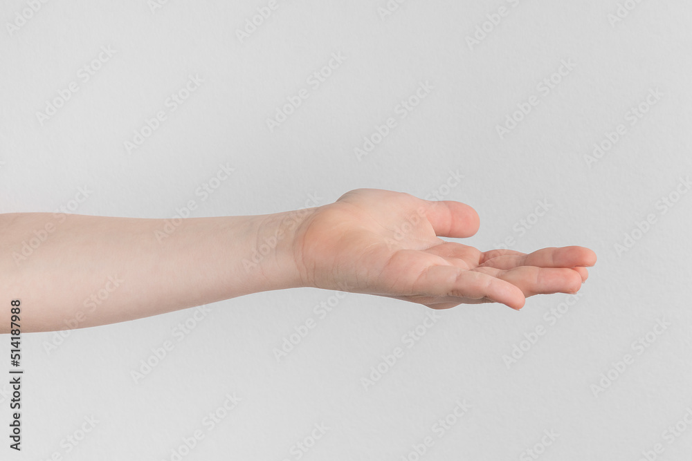 child hand palm up. side view Isolated on a white anf gray background close-up, copy space