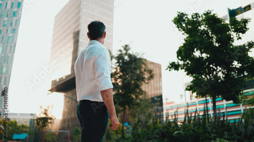 Wallpaper Mural Mature businessman with neat beard wearing white shirt stands in the financial district in the city. Successful man looks around on modern buildings background Torontodigital.ca