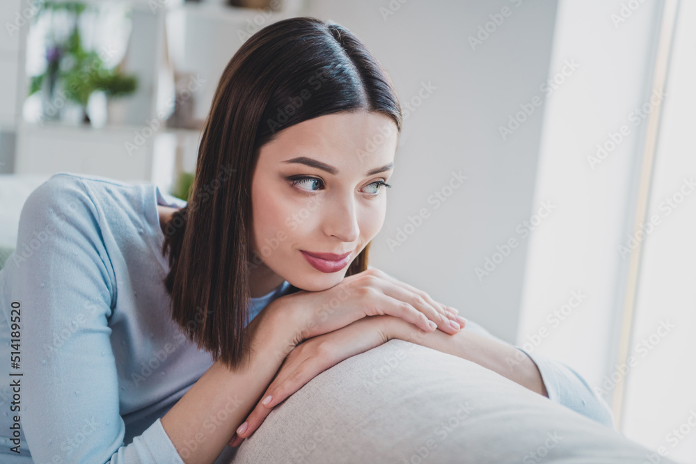 Portrait of attractive cheery dreamy calm peaceful woman sitting on divan resting lonely staying home indoors Portrait of attractive cheery dreamy calm peaceful woman sitting on divan resting lonely staying home indoors