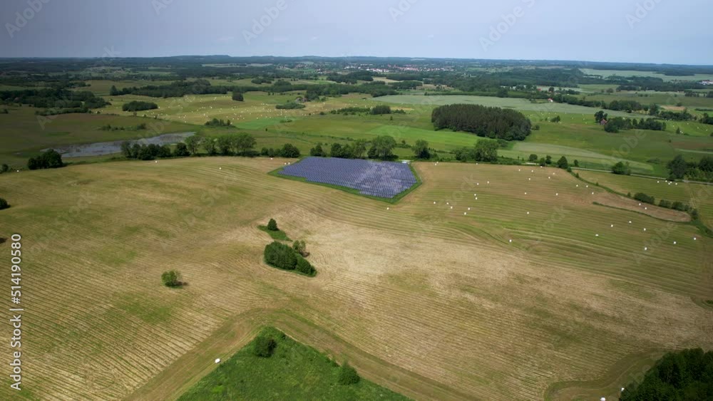 Empty Polish lands after harvesting crops with solar panel small farm - distant aerial view Empty Polish lands after harvesting crops with solar panel small farm - distant aerial view