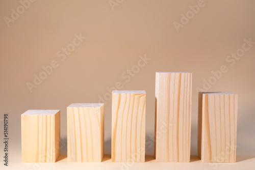 Podiums from wooden bars on a beige background