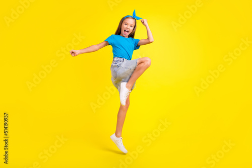 Full body portrait of overjoyed delighted person jump raise fists celebrate success isolated on yellow color background