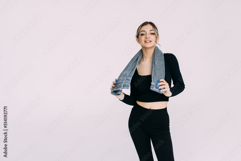 Portrait of natural sporty woman standing with towel around her neck isolated over white background Portrait of natural sporty woman standing with towel around her neck isolated over white background