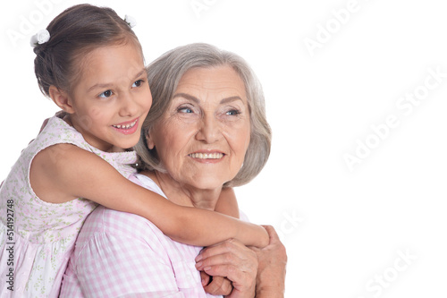 Grandmother hugging with her cute granddaughter isolated on white background