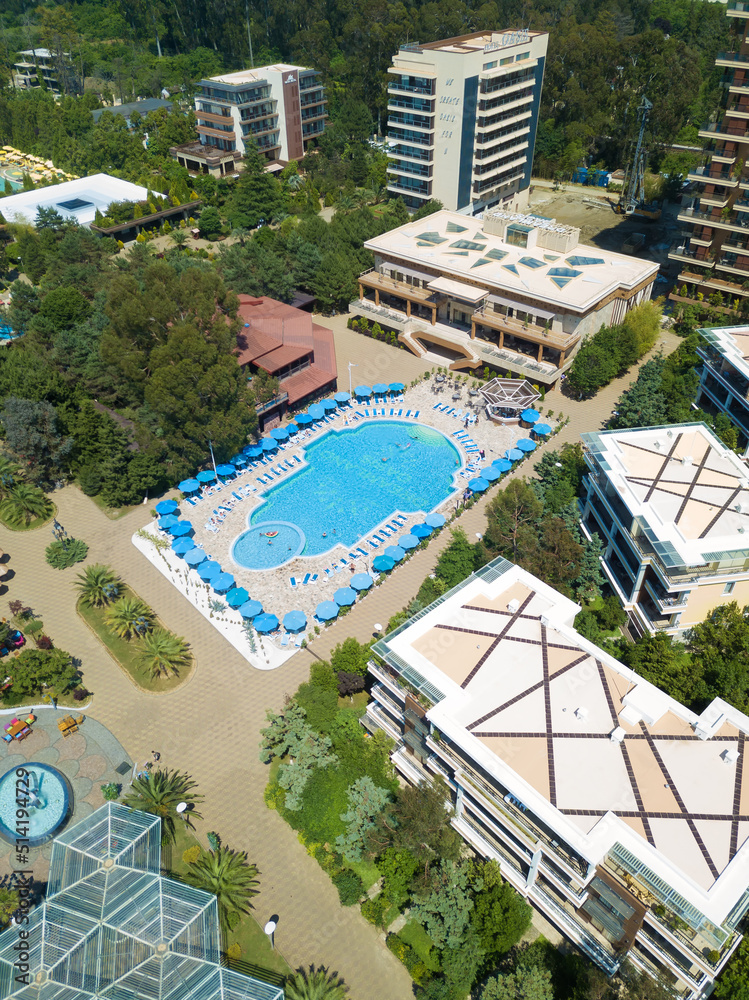 Beautiful view from the drone to the pool, the hotel grounds on a sunny day. Vertical photo
