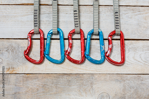 Set of climbing quickdraws on a wooden background photo