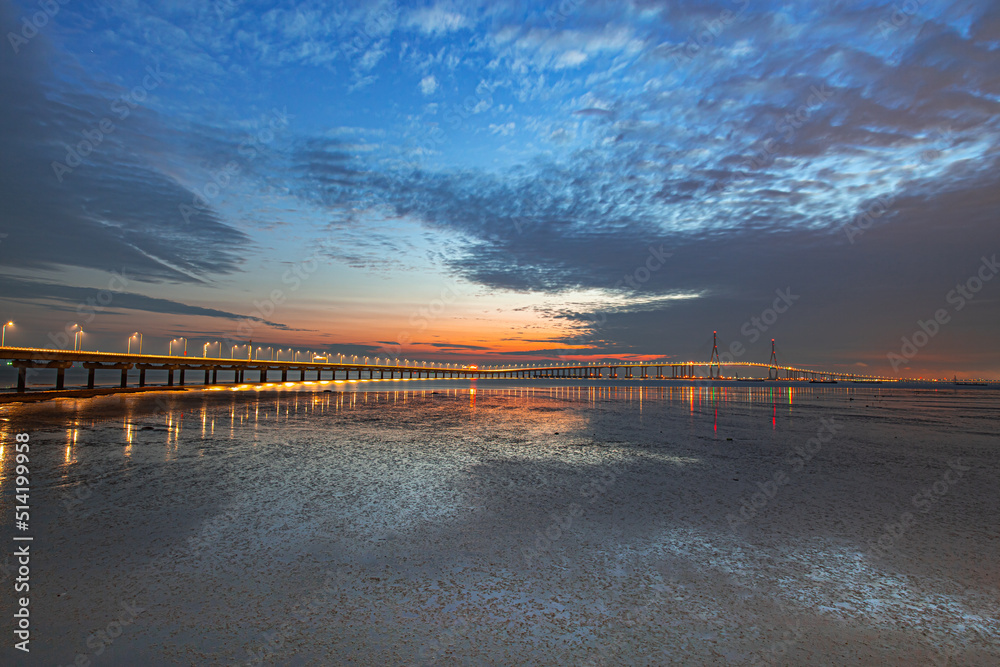 Bridge across the sea and evening sky with beautiful clouds
