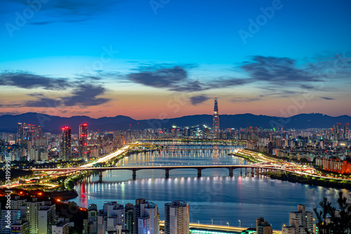 City landscape with flowing river before sunrise
