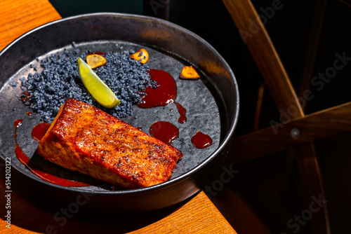 Grilled salmon steak with lemon, blue salt and sauce