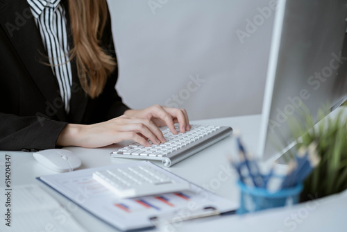 Asian businesswoman in formal suit in office happy and cheerful during using smartphone and working