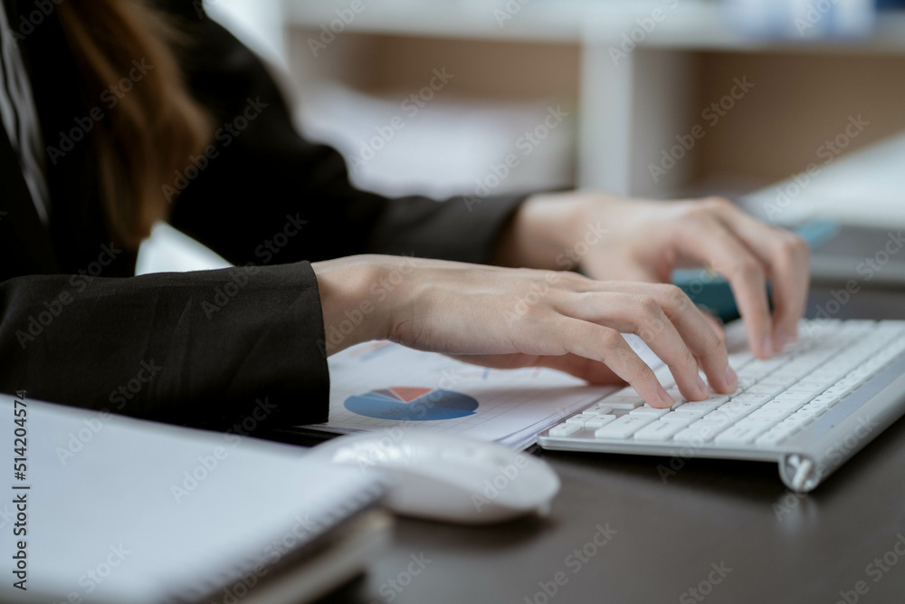 Asian businesswoman in formal suit in office happy and cheerful during using smartphone and working Asian businesswoman in formal suit in office happy and cheerful during using smartphone and working