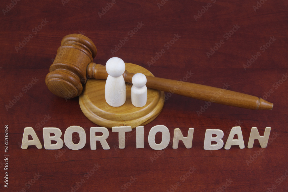 Laws about ban abortion concept. Letters abortion ban with judge gavel and figures of female and child. Laws about ban abortion concept. Letters abortion ban with judge gavel and figures of female and child.