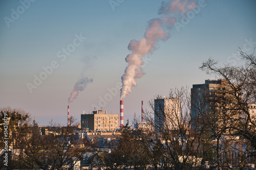 Warsaw, Poland - 01.23.2022: chimney blowing smoke, factory in Warsaw