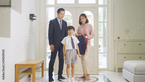 Portrait of happy smiling Asian Family. A student prepaing to go to school at home or house  in family relationship. Love of father, mother, and son. People lifestyle.