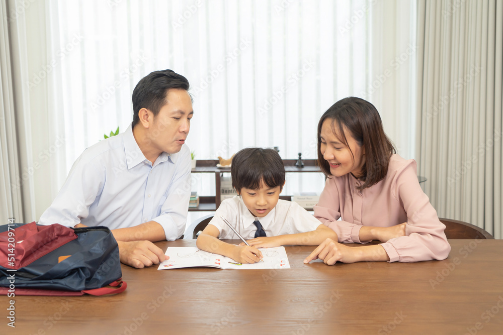 Portrait of happy smiling Asian Family. A student studying homework from school at home or house in family relationship. Love of father, mother, and son. People lifestyle. Education activity. Portrait of happy smiling Asian Family. A student studying homework from school at home or house in family relationship. Love of father, mother, and son. People lifestyle. Education activity.
