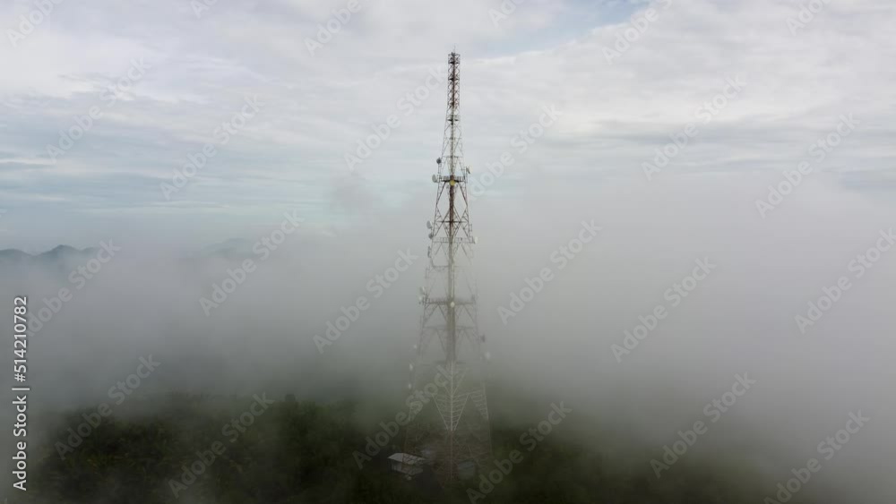 Aerial ascending telco tower in the foggy cloud Aerial ascending telco tower in the foggy cloud