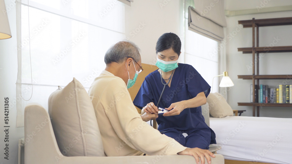 Obraz premium Happy woman nurse, daughter taking a covid test to sick old senior elderly patient lying on bed in bedroom in home in medical. Coronavirus. Asian Thai people lifestyle. Family
