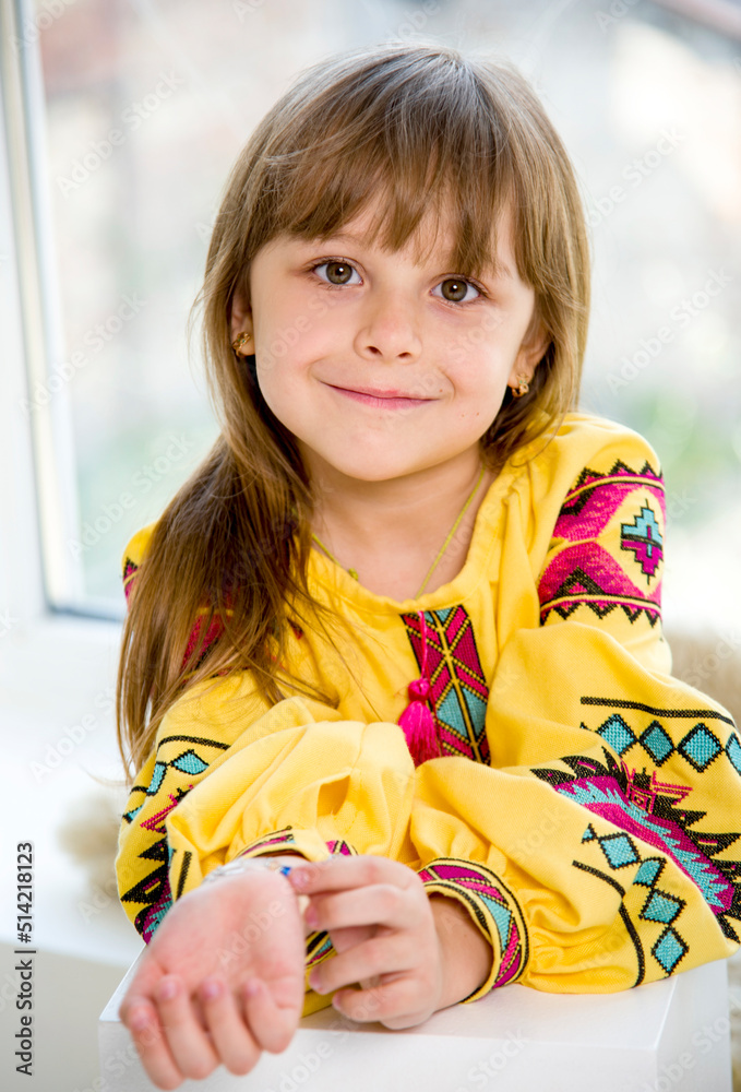 portrait of happy smiling cute little girl in beautiful ukrainian yellow embroidery portrait of happy smiling cute little girl in beautiful ukrainian yellow embroidery