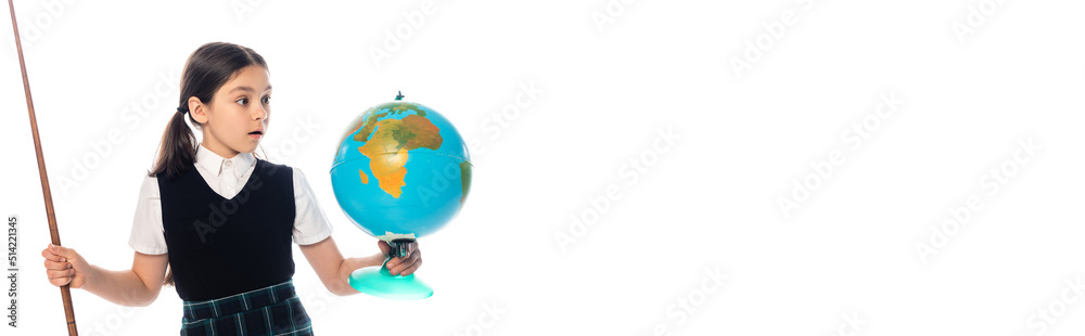 Fototapeta premium Amazed schoolchild holding pointer and looking at globe isolated on white, banner.