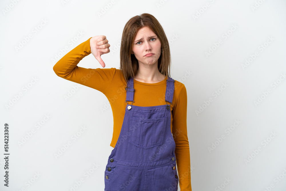 Young English woman isolated on white background showing thumb down with negative expression Young English woman isolated on white background showing thumb down with negative expression