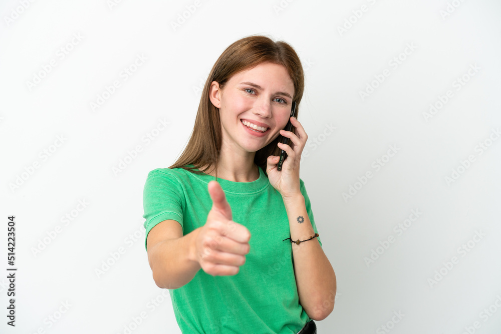 Young English woman isolated on white background keeping a conversation with the mobile while doing thumbs up Young English woman isolated on white background keeping a conversation with the mobile while doing thumbs up