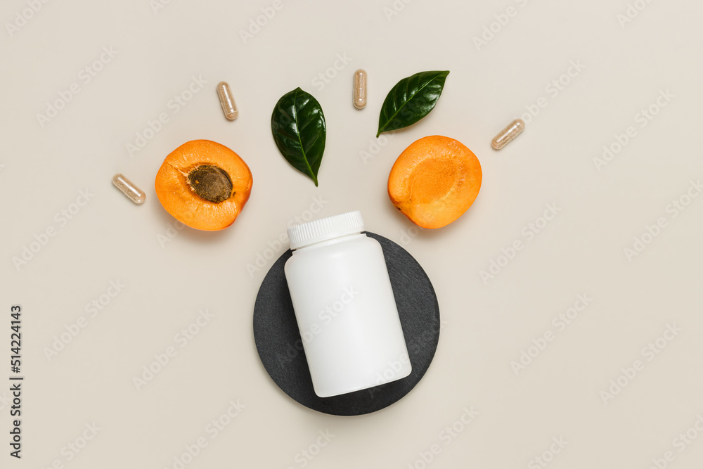 Mockup bottle of vitamins with apricots, pills and leaves for good vision. Top view, flat lay, organic supplement